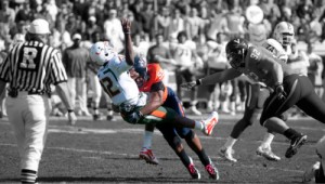 Quarterback Jacory Harris is hit by defensive tackle John-Kevin Dolce at the Miami vs. Virginia game in October.