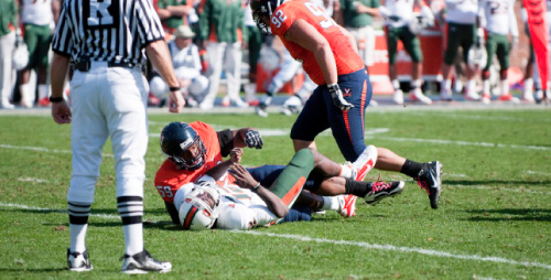 Jacory Harris lies on the ground after being taken down by defensive tackle John-Kevin Dolce at the Miami vs. Virginia game in October.