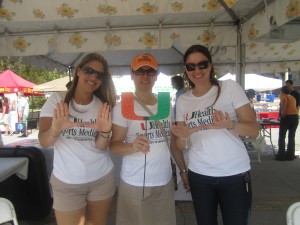 Miller school students throw up the U at the Farmer's Market.